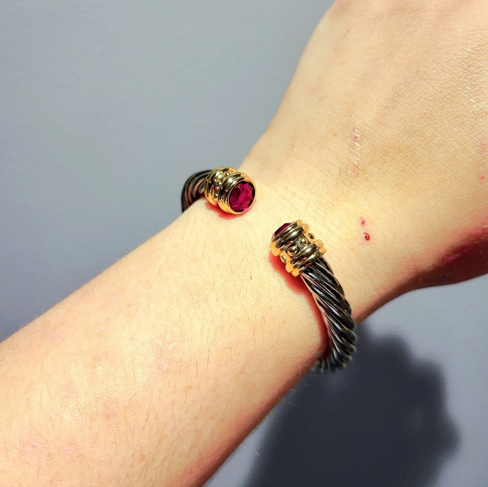 A Joan Rivers, OS,sterling silver with a hint of plated gold&purple CZ diamonds.